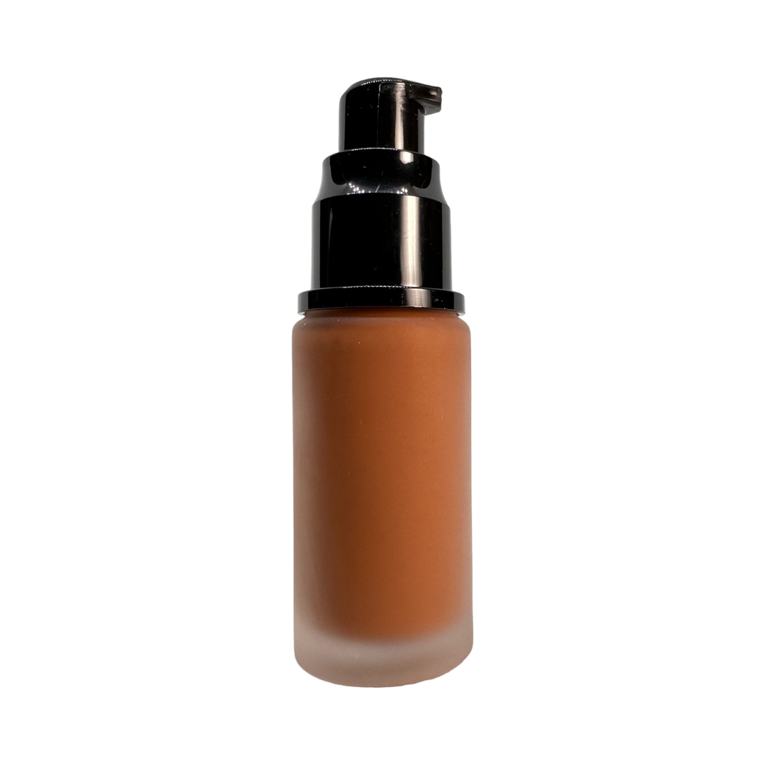 RadiantGlow Liquid Makeup Foundation bottle with a drop of foundation, showcasing its smooth texture and flawless finish